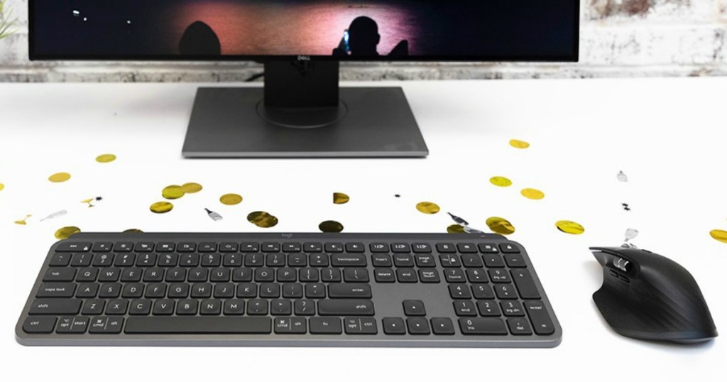 Logitech MX keyboard and mouse on desktop with golden confetti