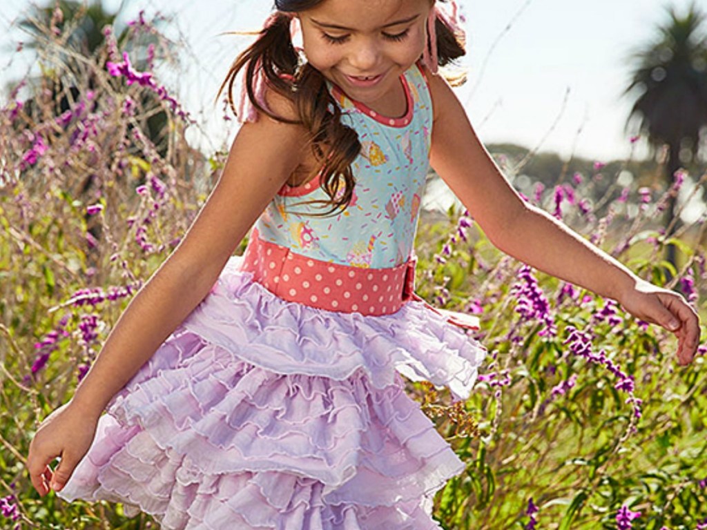 girls in a garden of flowers with a Matilda dress on