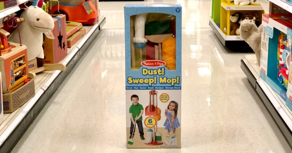 Melissa & Doug brand toy set with pretend duster, broom, and mop in package in store aisle