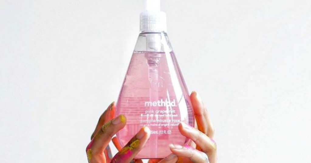 hands holding bottle of Method Pink Grapefruit hand soap