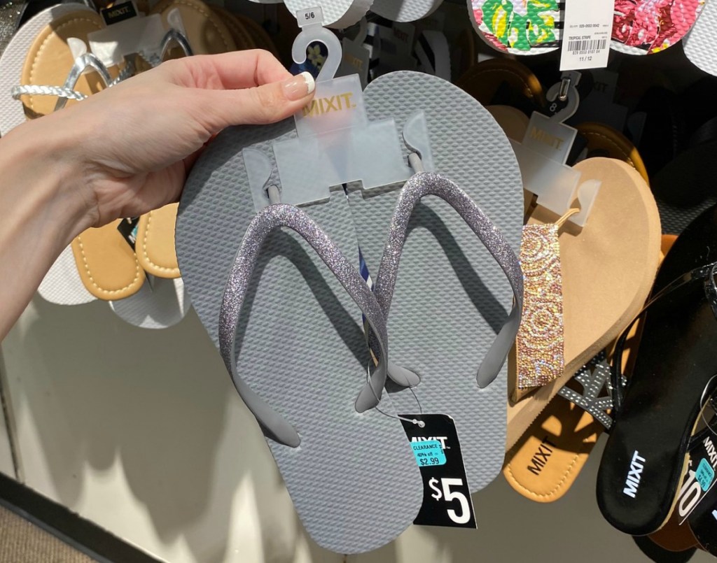 gray flip flops on hanger in-store