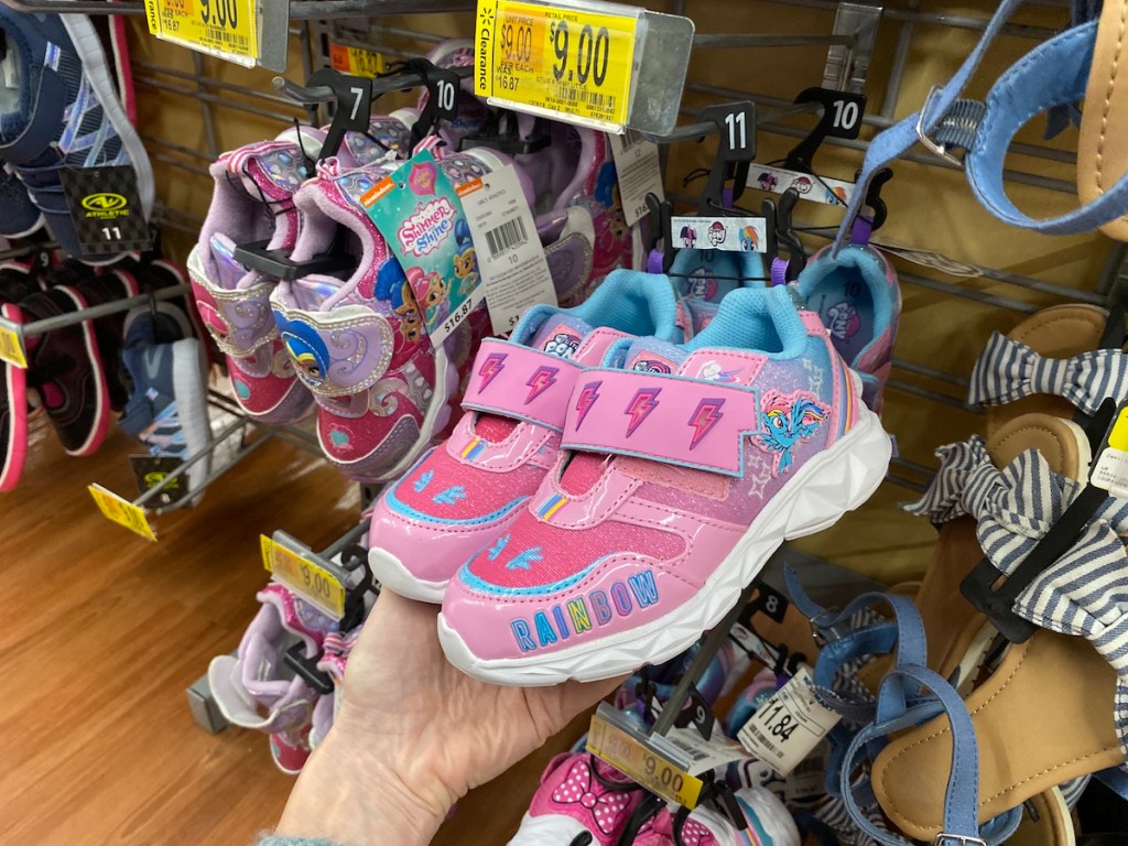 hand holding pair of My Little Pony Sneakers