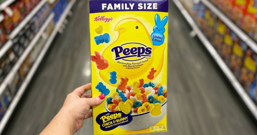 Woman's hand holding the new Kellogg's brand Peeps cereal box in a family size