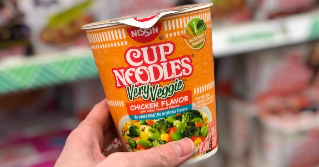 Cup of Noodles in hand near in-store display