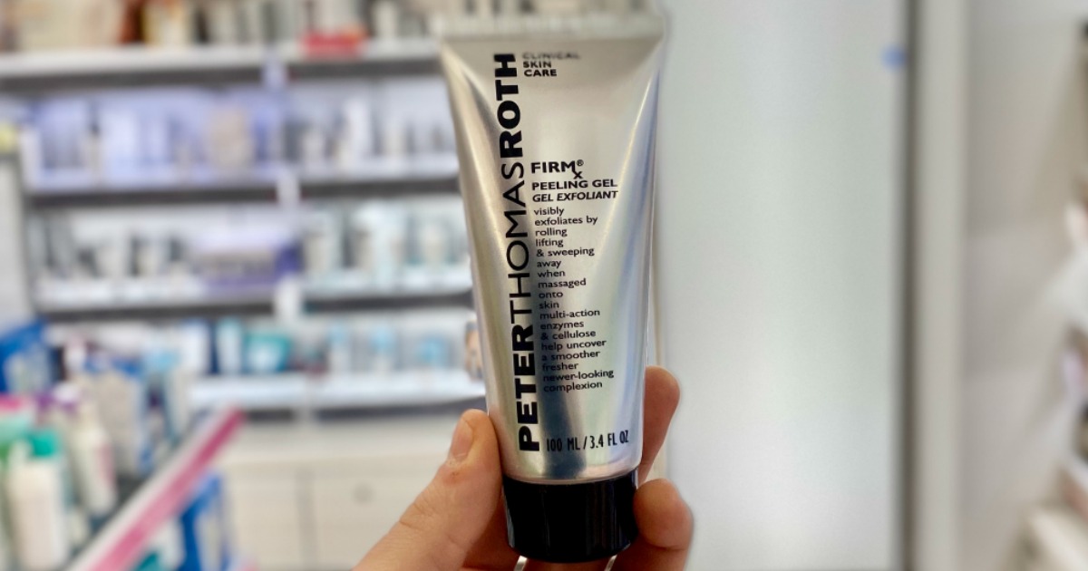 hand holding bottle of Peter Thomas Roth FirmX