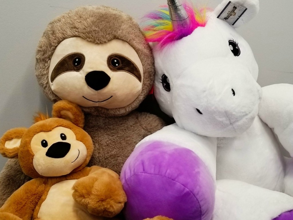 Three plush stuffed animals - sloth, unicorn and bear