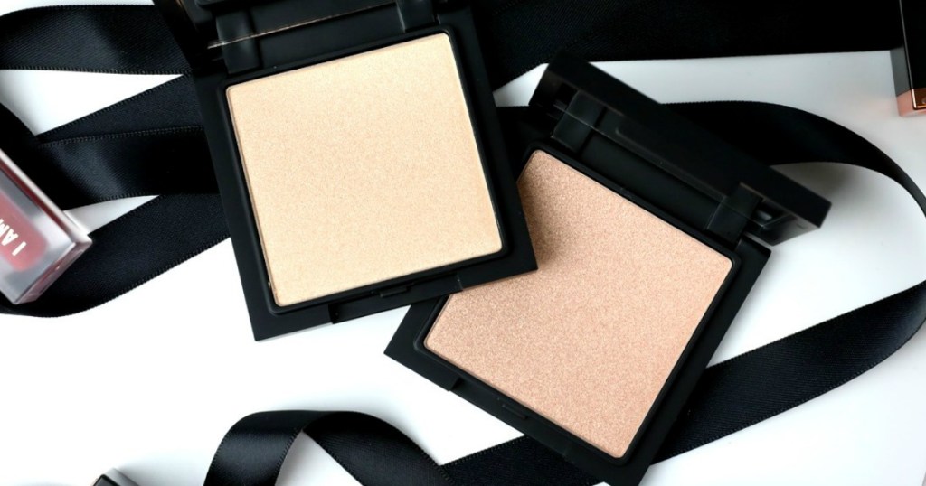 RealHer Beauty Highlighters in two colors on table top with black ribbon