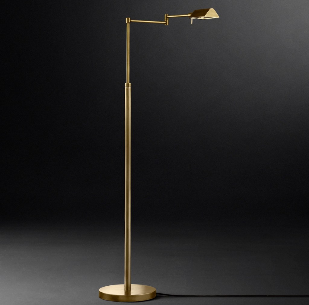 gold task floor lamp with black and gray background