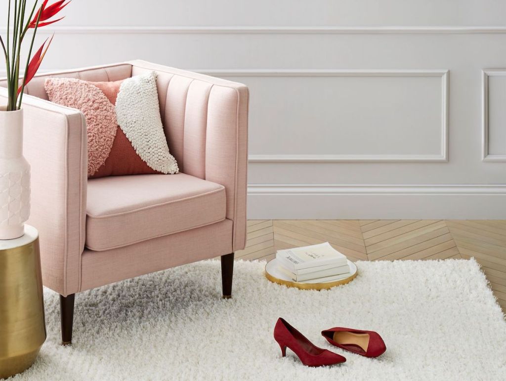 Saffiano Chair with pillow on it next to plant on rug with shoes on the rug