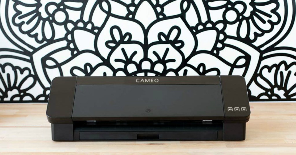 Silhouette Cameo 4 sitting on desk with pattern behind it