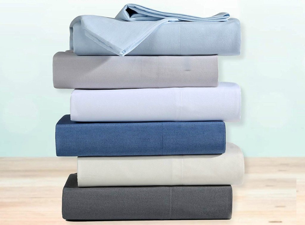 Stack of flat bed sheets folded and in shades of blue