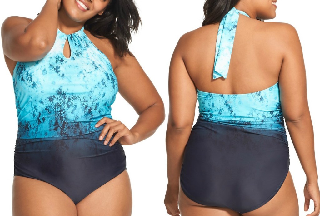 Woman wearing a teal and navy one-piece halter swimsuit