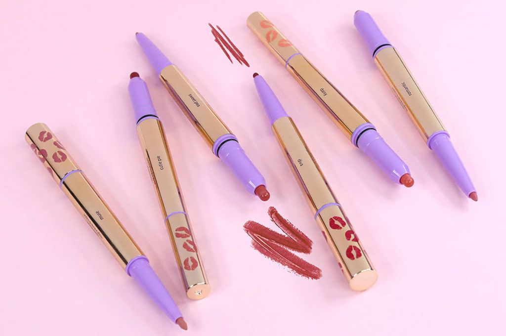 Tarte Lip Architects laying on pink background with scribble on background