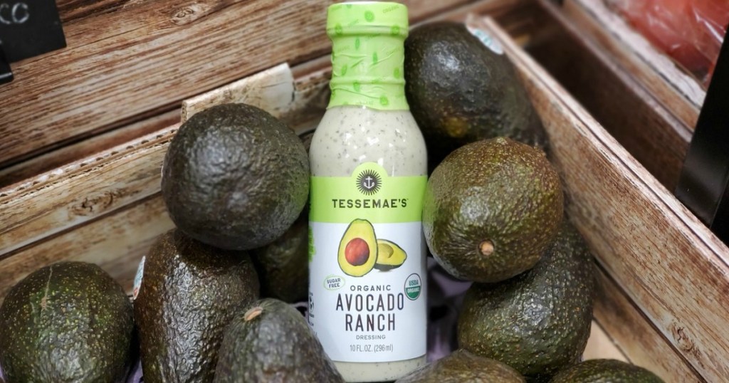 Tessemae's Organic Avocado Ranch Dressing nestled among avocados