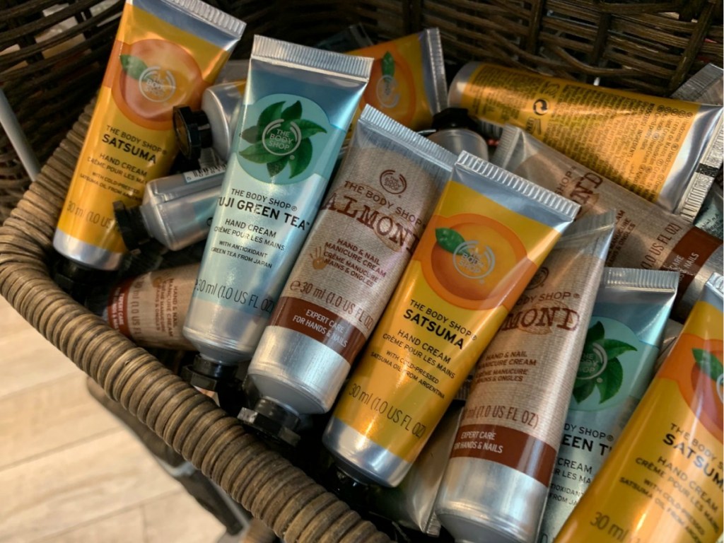 Tubes of hand cream in a basket in-store on display