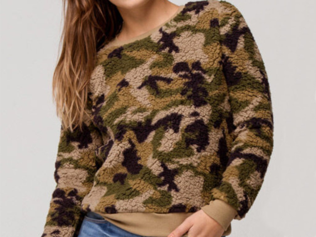 Woman wearing camo fuzzy sweater from tilly's