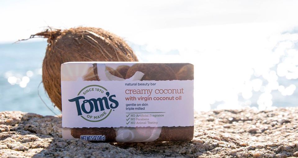 Tom's of Maine Creamy Coconut Bar on beach next to coconut