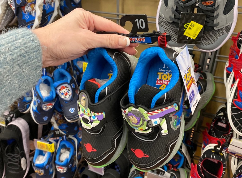 hand holding pair of Toy Story Shoes
