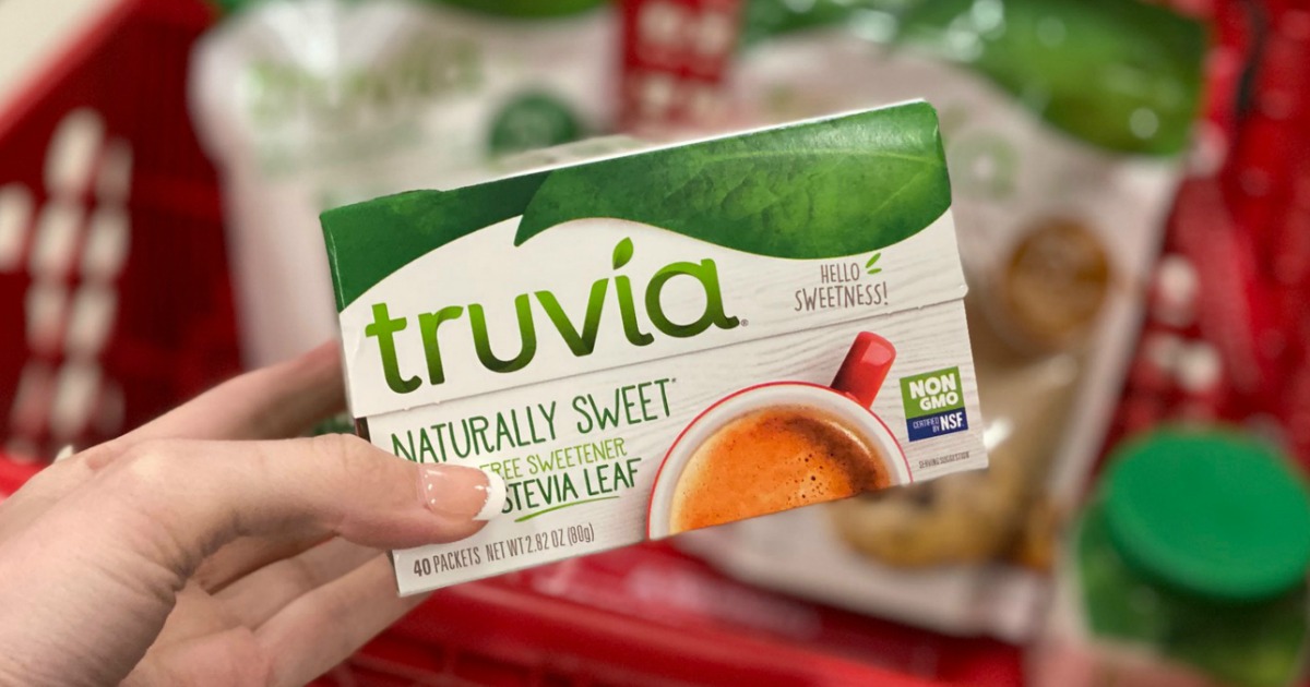 hand holding box of Truvia in front of Target cart