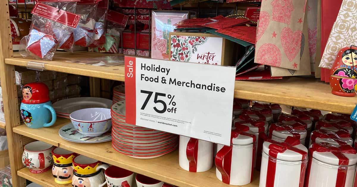 world market holiday clearance shelves full of merchandise with a sign saying 75% off 