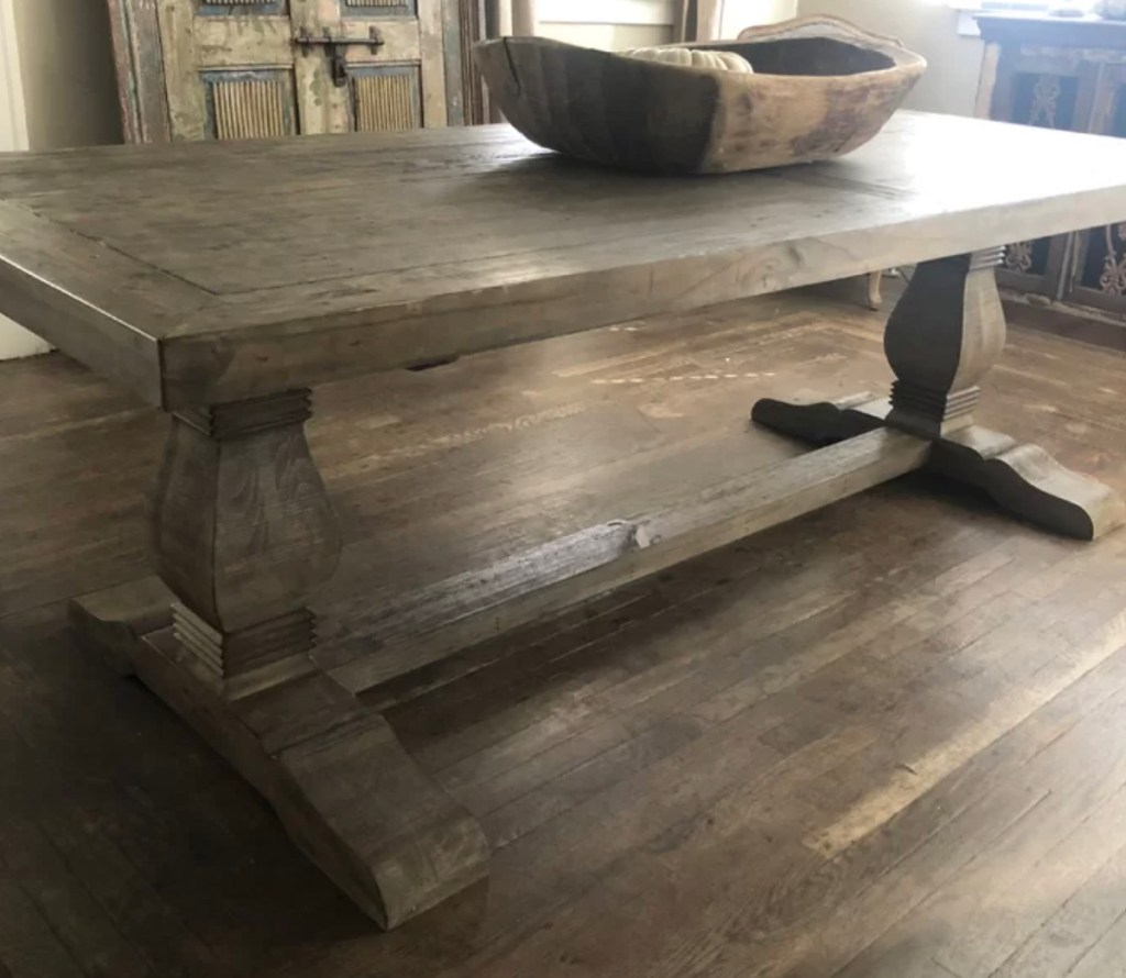 rectangular dining table with wood tray on top sitting on empty floor
