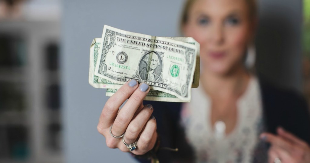 woman holding dollar bills in her hand