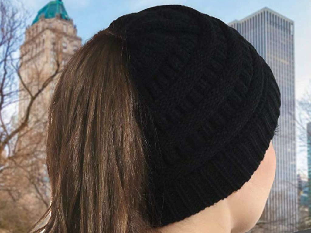 Woman wearing a cable knit beanie hat outdoors