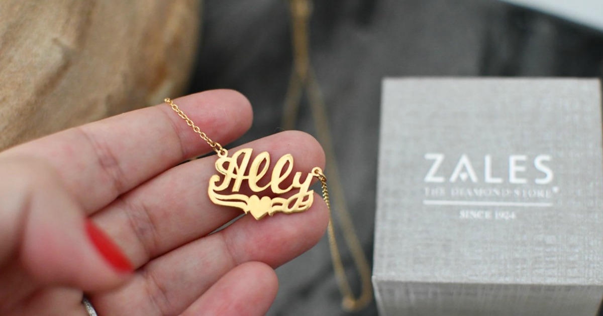 hand holding gold name necklace next to Zales box