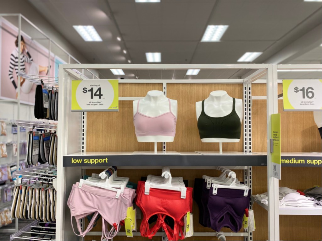 all in motion sports bras hanging in store with $14 price sign