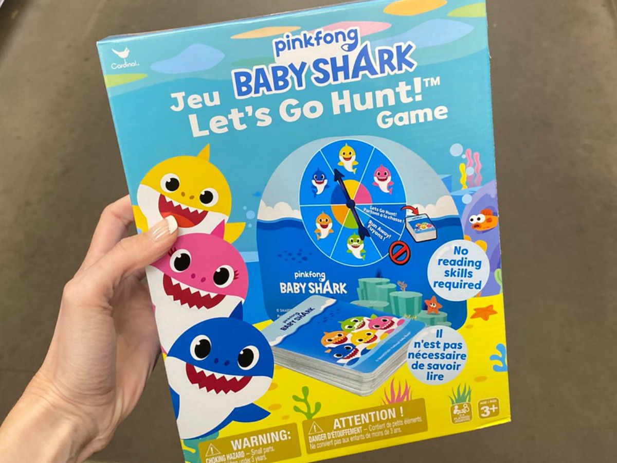 hand holding game for kids with baby sharks on it