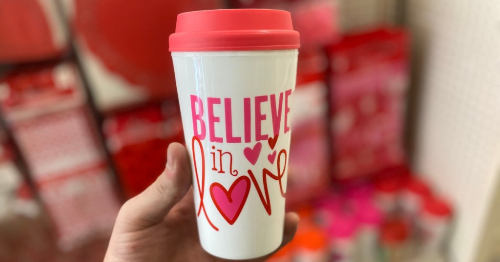hand holding believe in love cup with blurred background