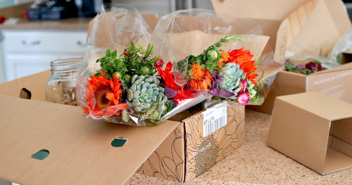 flowers wrapped in plastic sitting in brown cardboard boxes