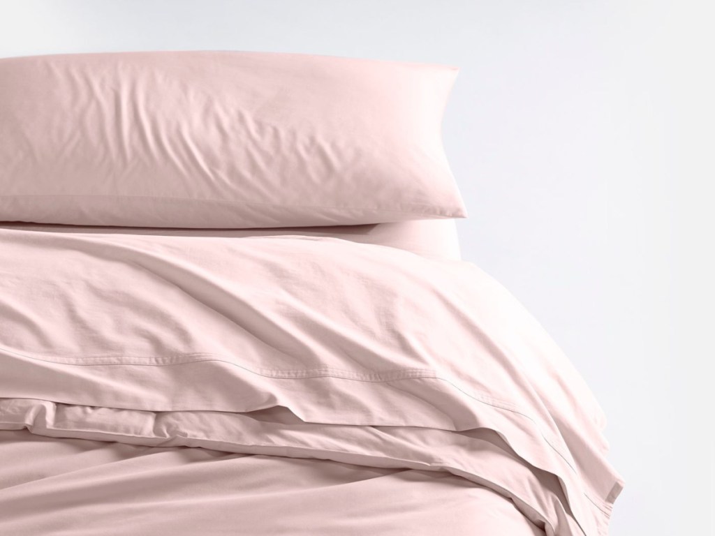 pale pink sheets with pillow case on bed