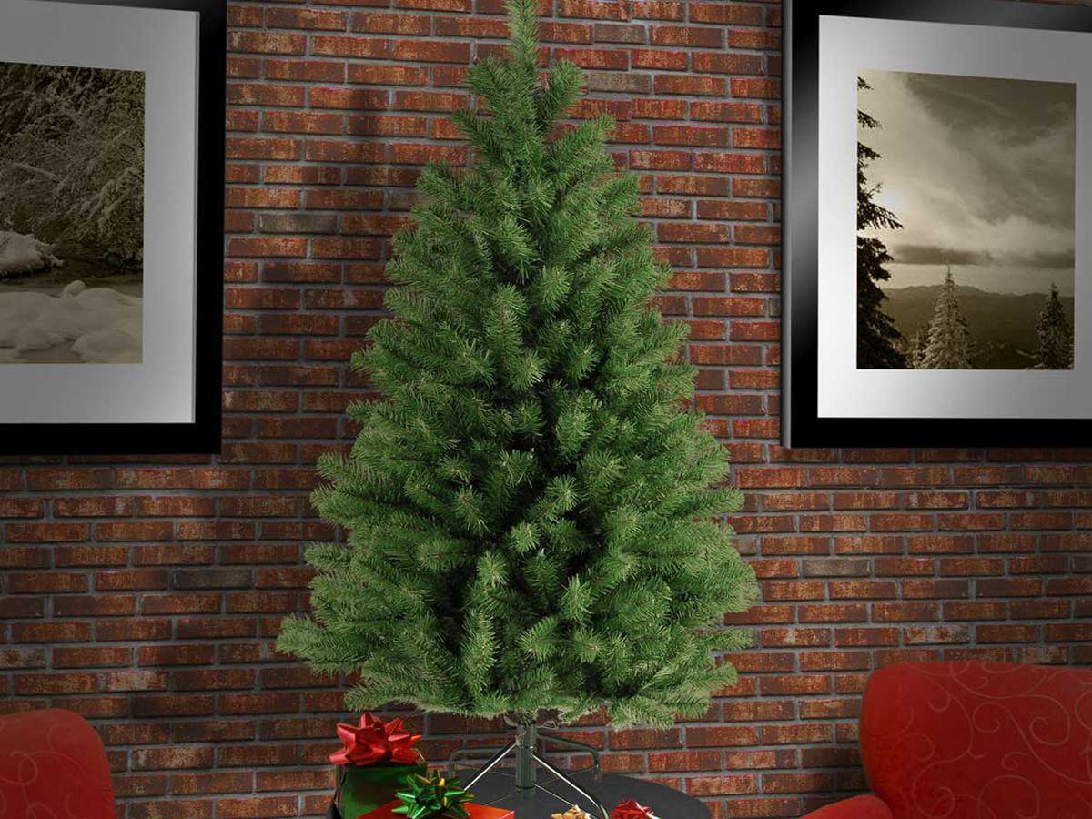 Home Accents Holiday 4.5' Unlit North Valley Spruce Artificial Christmas Tree in a living room