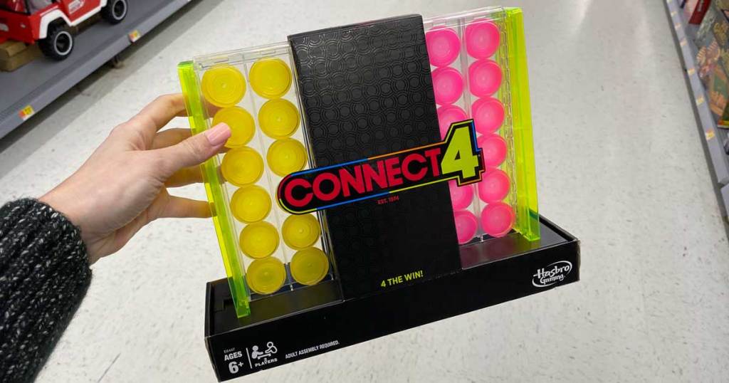 woman holding Connect 4 Neon Pop Board Strategy Game