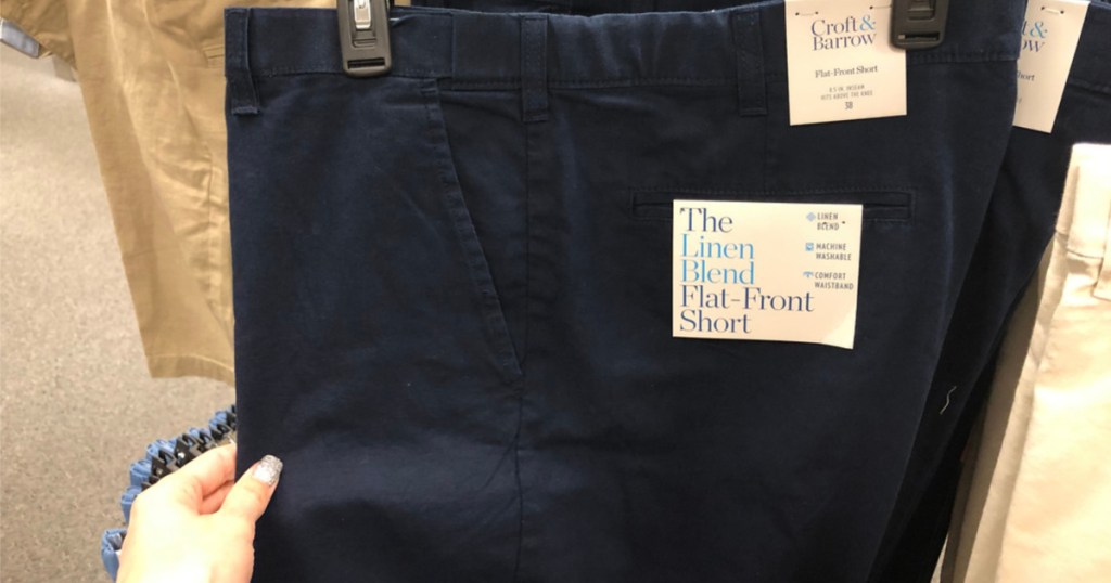 hand touching blue croft & barrow shorts in store