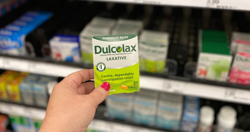 hand holding dulcolax laxative with blurred background