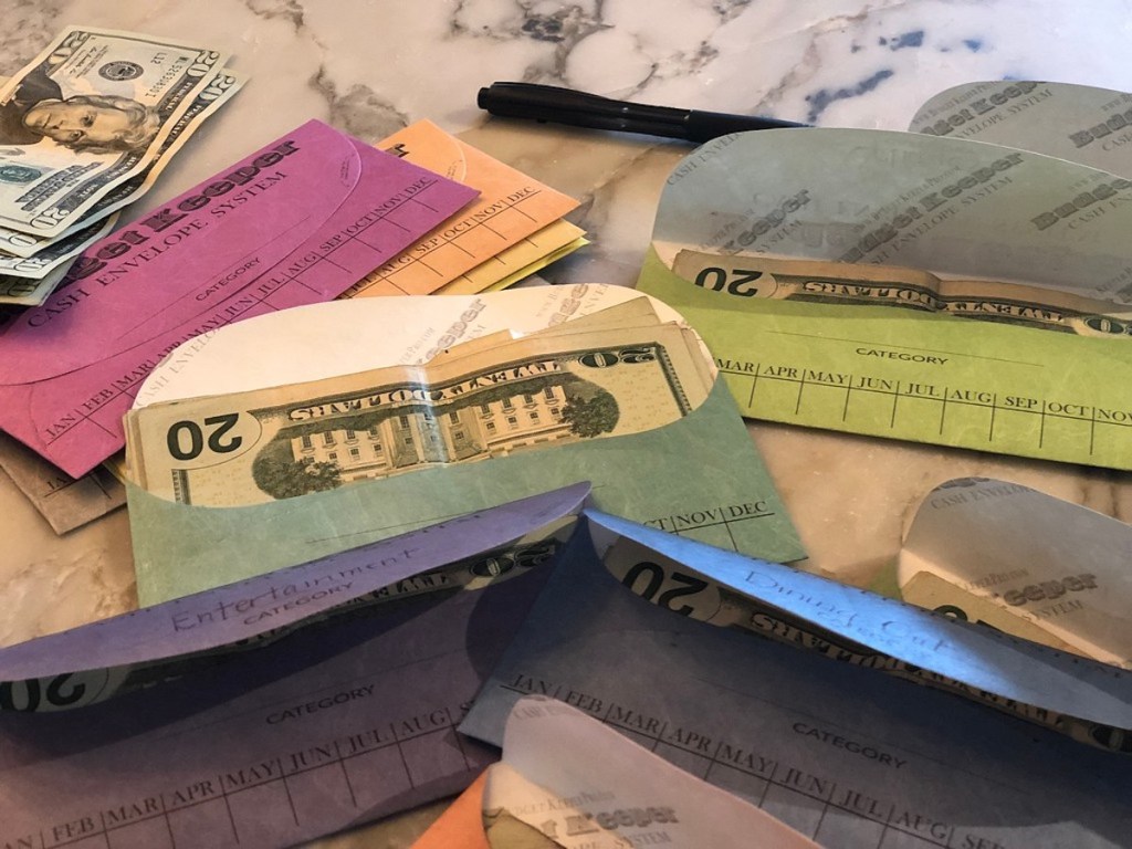 envelopes sitting on counter with money inside best way to save money saving