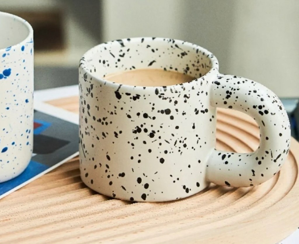 white and black speckled mug on arch tray