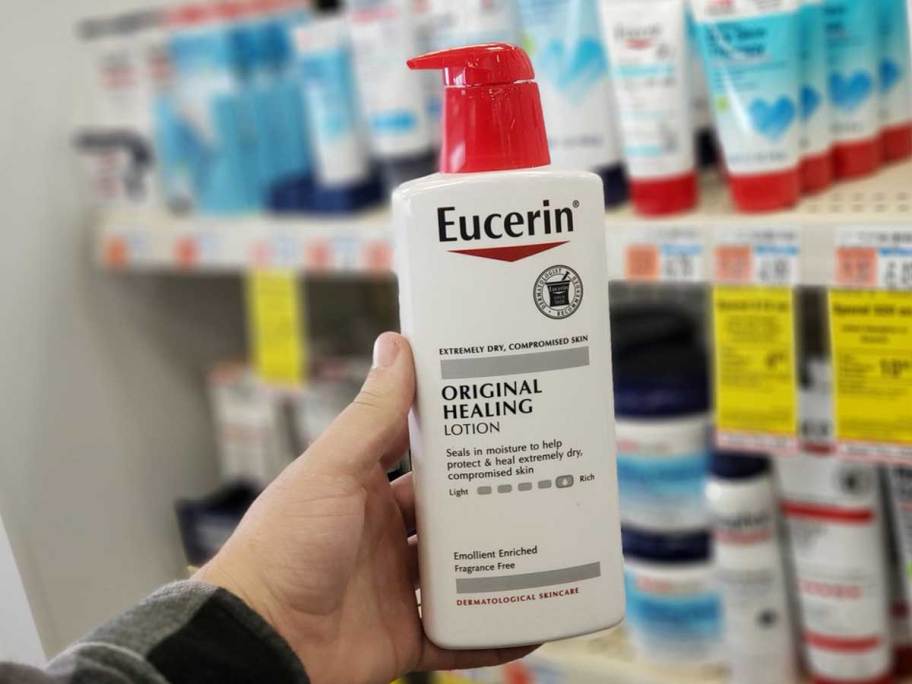hand holding eucerin lotion bottle 