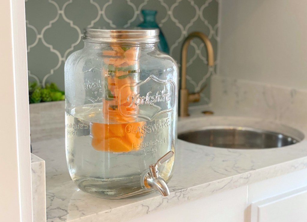 glass jug of water with fruit 