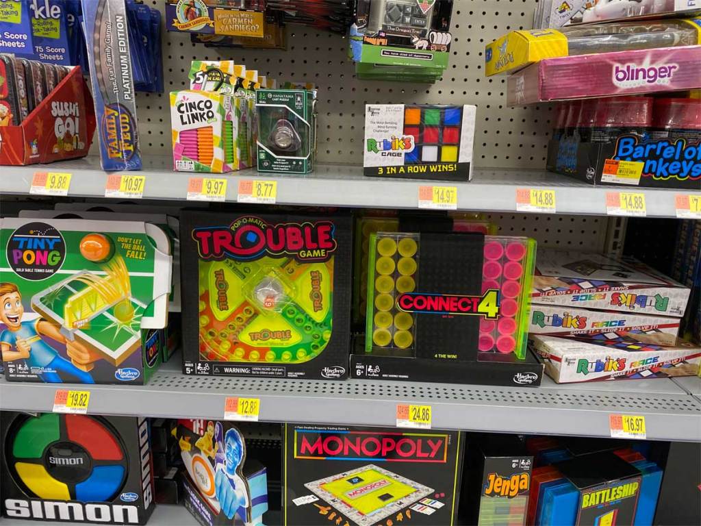 neon pop board games on a shelf in a store