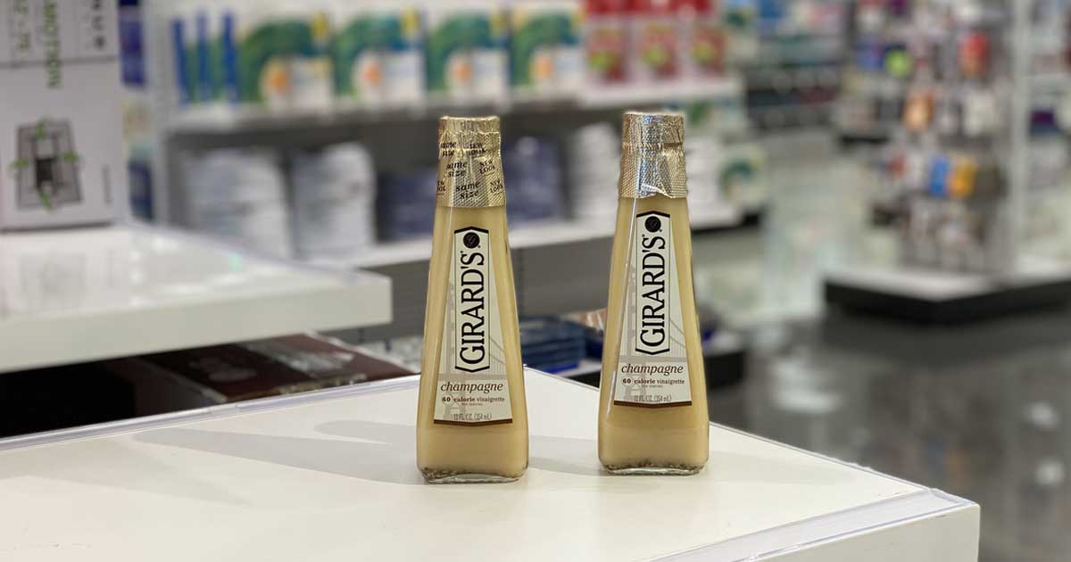 two bottles of salad dressing on a shelf in a store