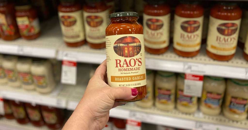 woman's hand holding a jar of Rao's Homemade sauce