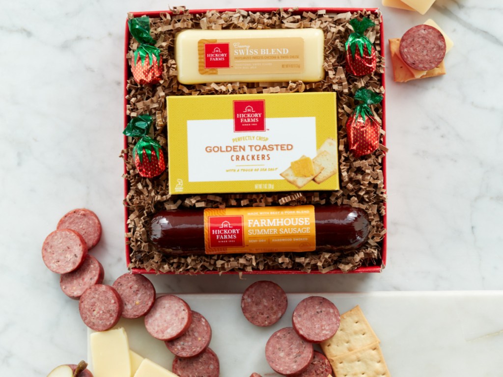 crackers, cheese and sausage gift box with sausage crackers and cheese on table
