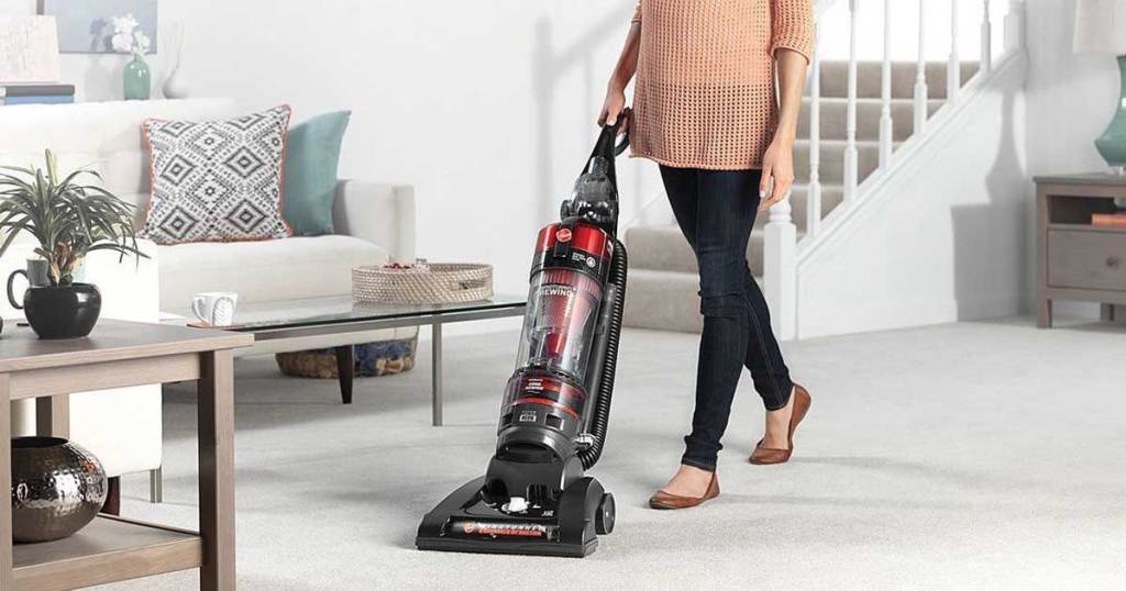 woman using a Hoover WindTunnel 2 Rewind Pet Upright Bagless Vacuum in the living room