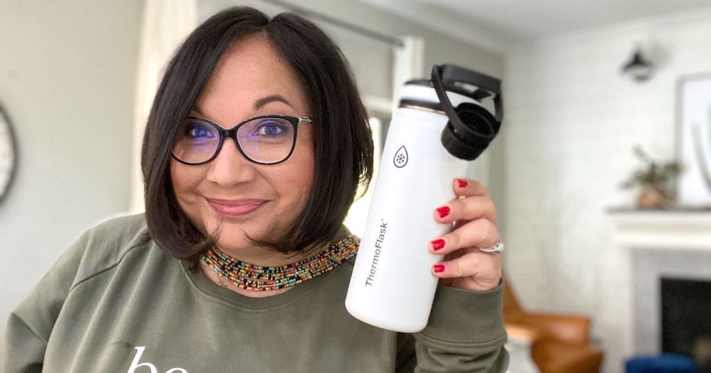 woman holding white and black water bottle