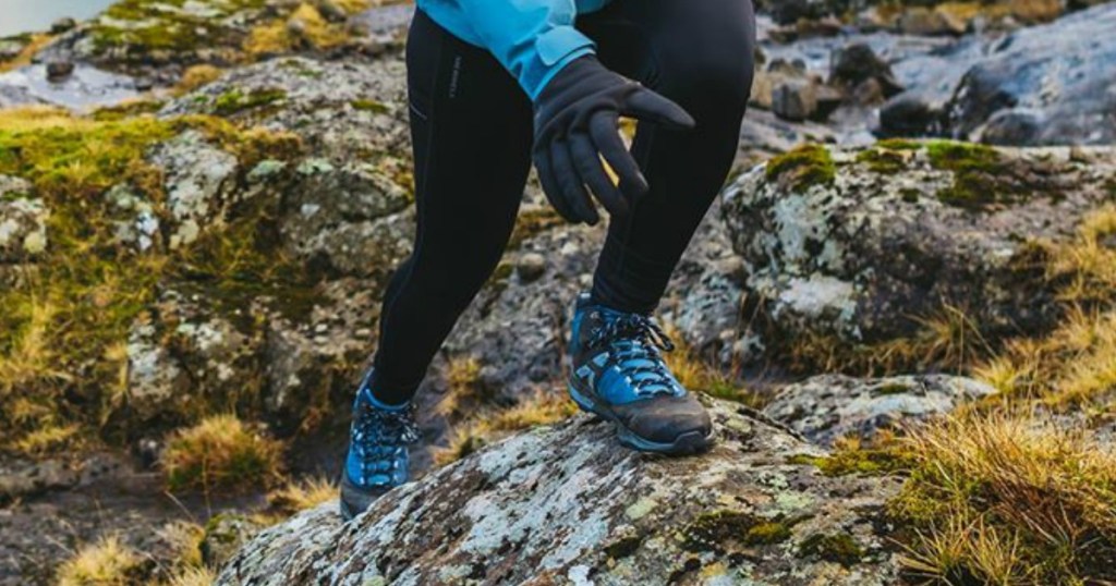 legs with blue hiking shoes going up a mountain