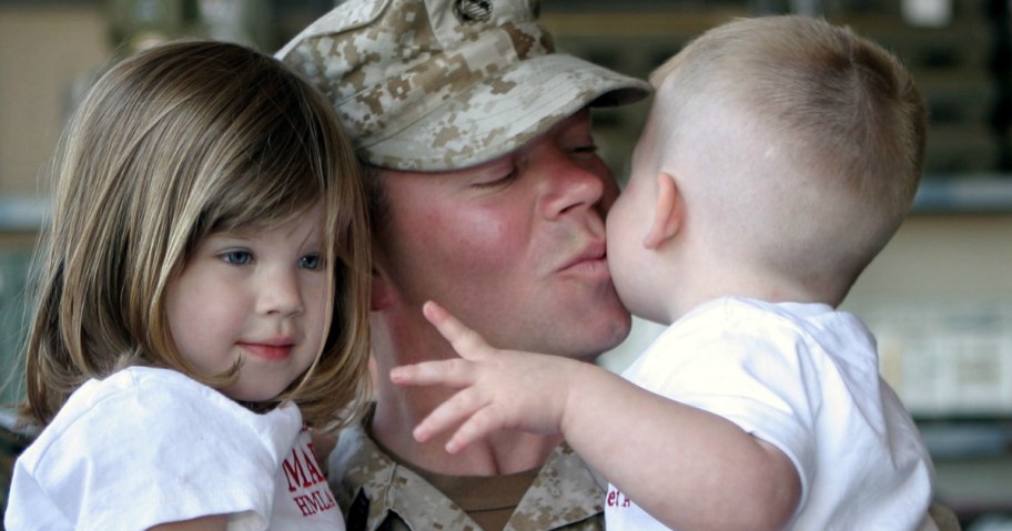 military dad kissing kids