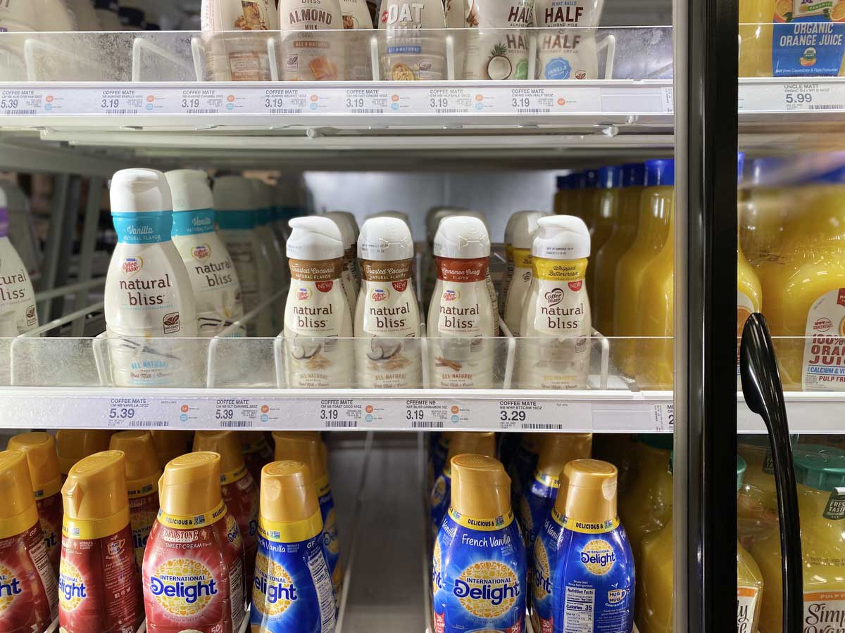 Coffee-Mate Natural Bliss creamer on shelves in a fridge in a store